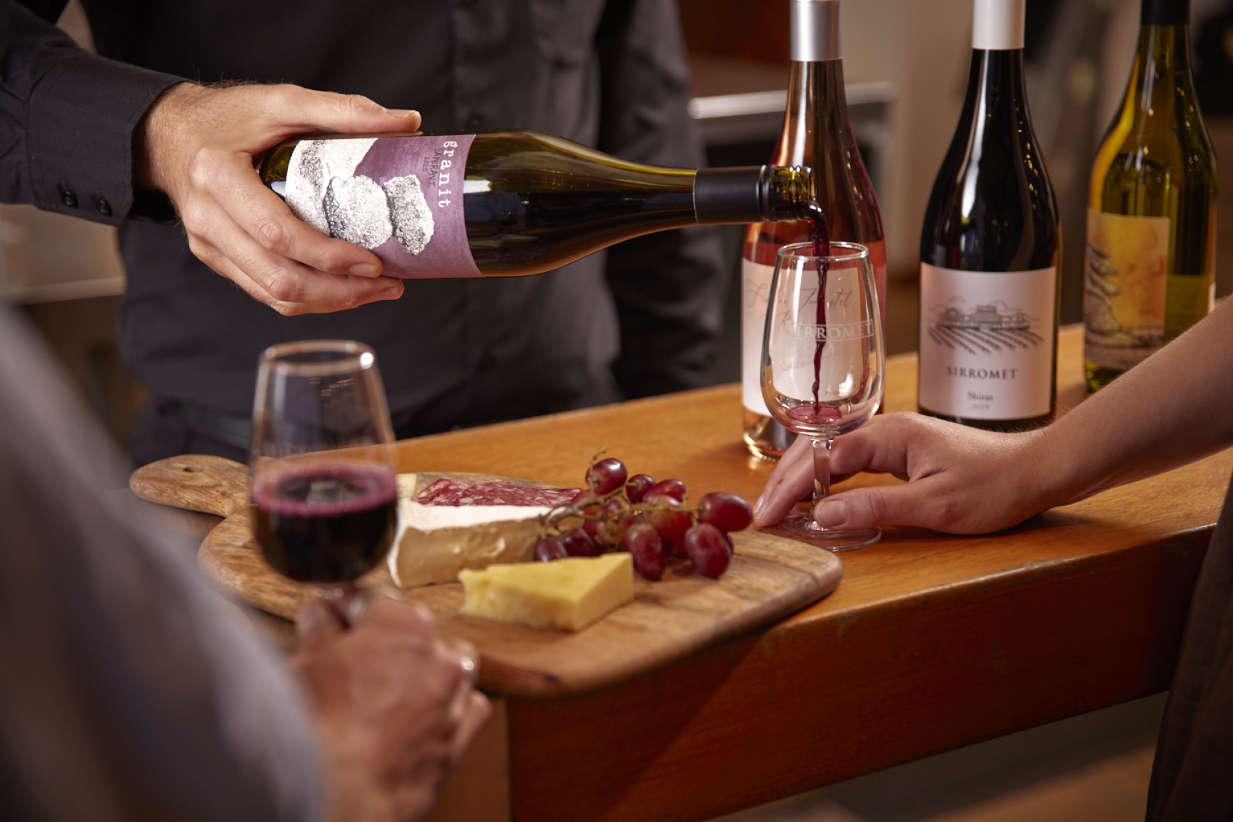 Man pouring wine into a wine glass